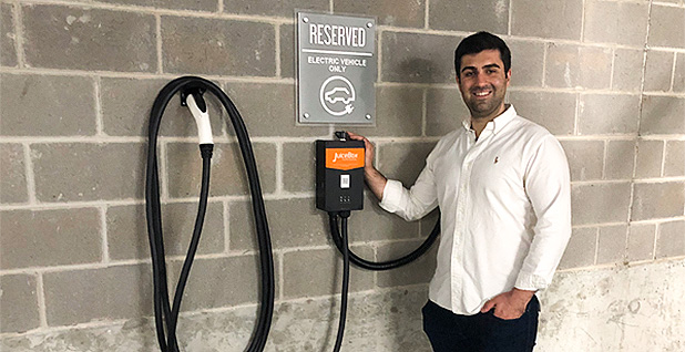 Chris from Electrical Plumbing Pros standing next to an EV charging station